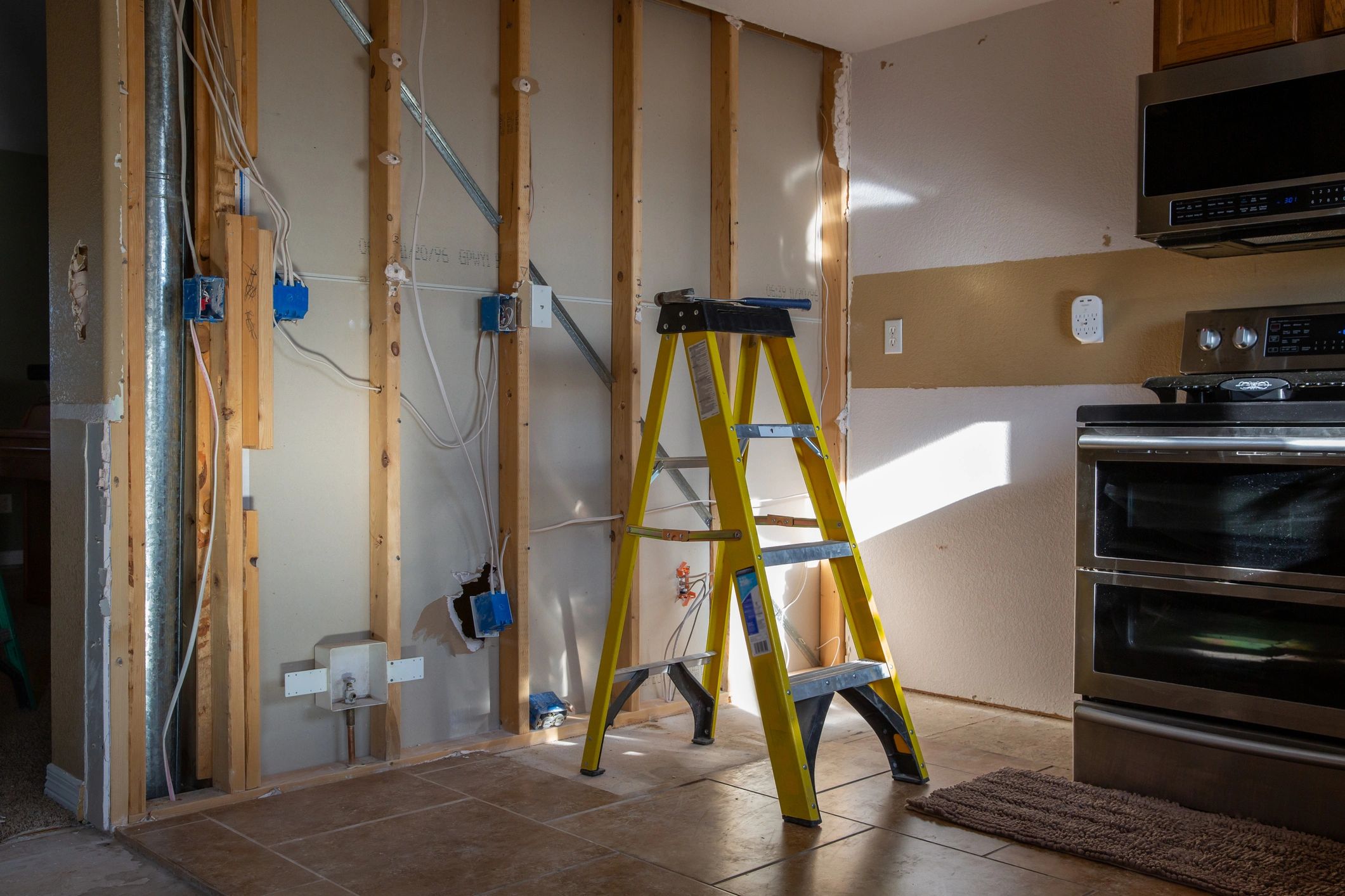 Modern hallway with ceiling fan and wall sconces