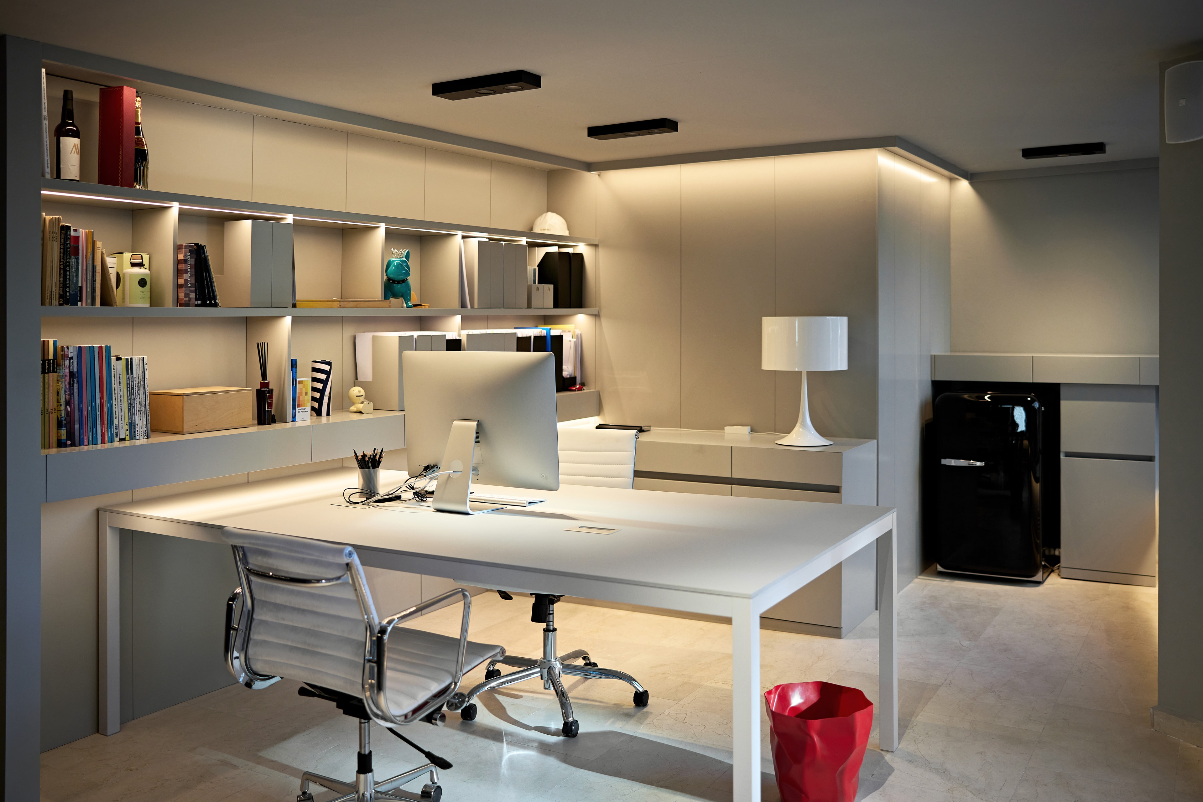 Modern open-plan office space with ambient recessed lighting and clean architectural finishes