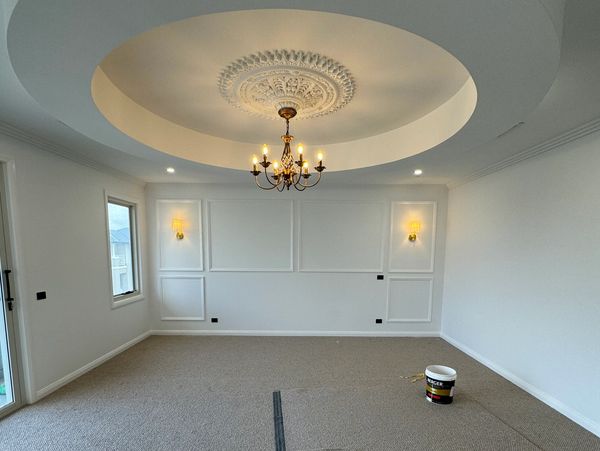 Modern interior with ceiling fan and circular wall sconces