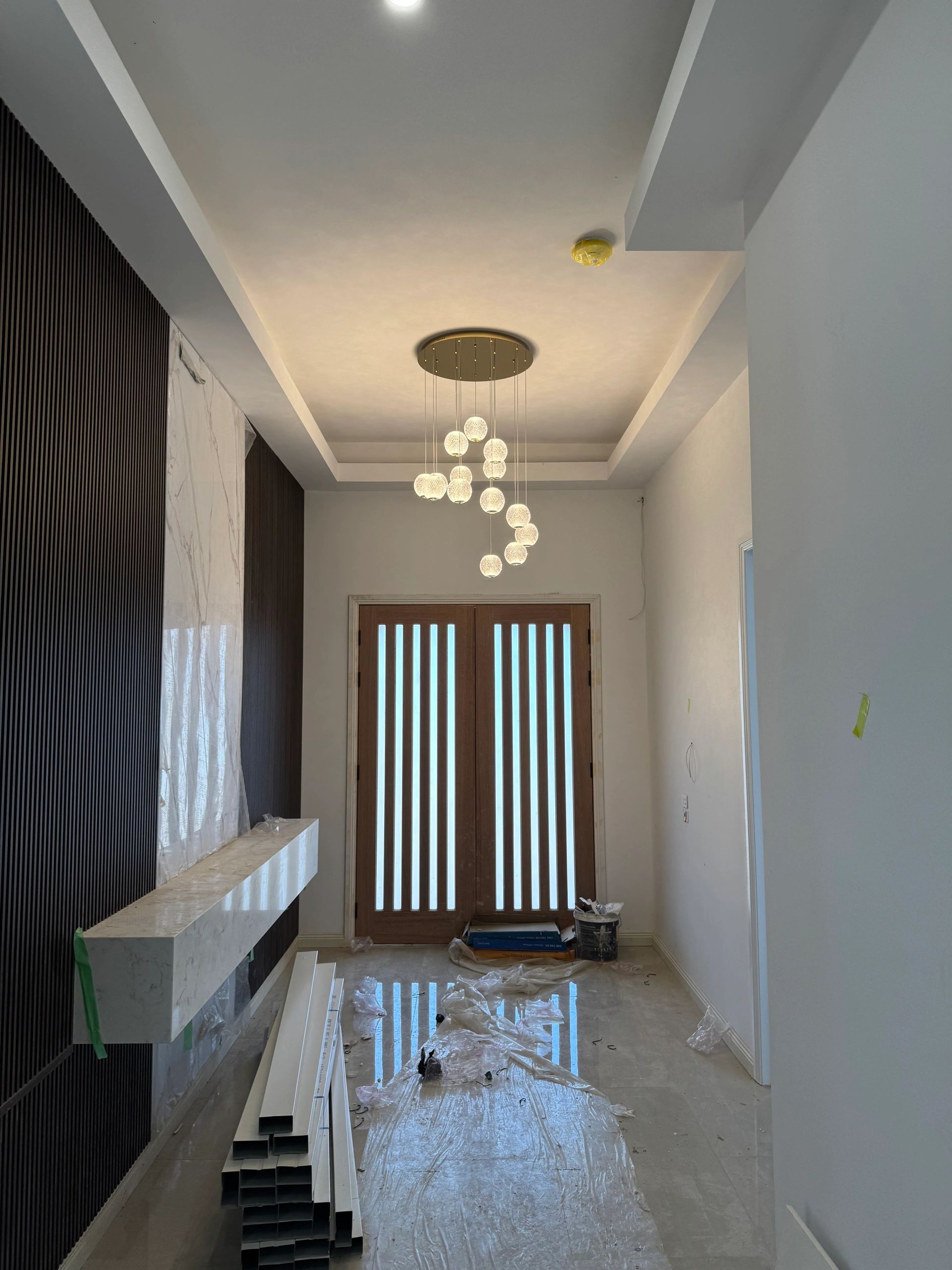 Modern hallway with white walls and pendant lighting